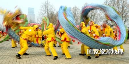  在鄭州市舉辦的一個(gè)元宵節(jié)舞龍大賽上，一支舞龍隊(duì)在表演高難度動(dòng)作（2011年2月16日攝）。元宵節(jié)，除了觀賞花燈外，最熱鬧的活動(dòng)當(dāng)屬傳統(tǒng)民俗表演。在中原地區(qū)，從正月十三開始，各地都要連續(xù)數(shù)日舉辦各種大型文藝表演活動(dòng)。